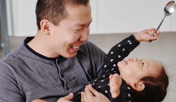 somatic therapy partners man holding daughter laughing together man holding daughter laughing together